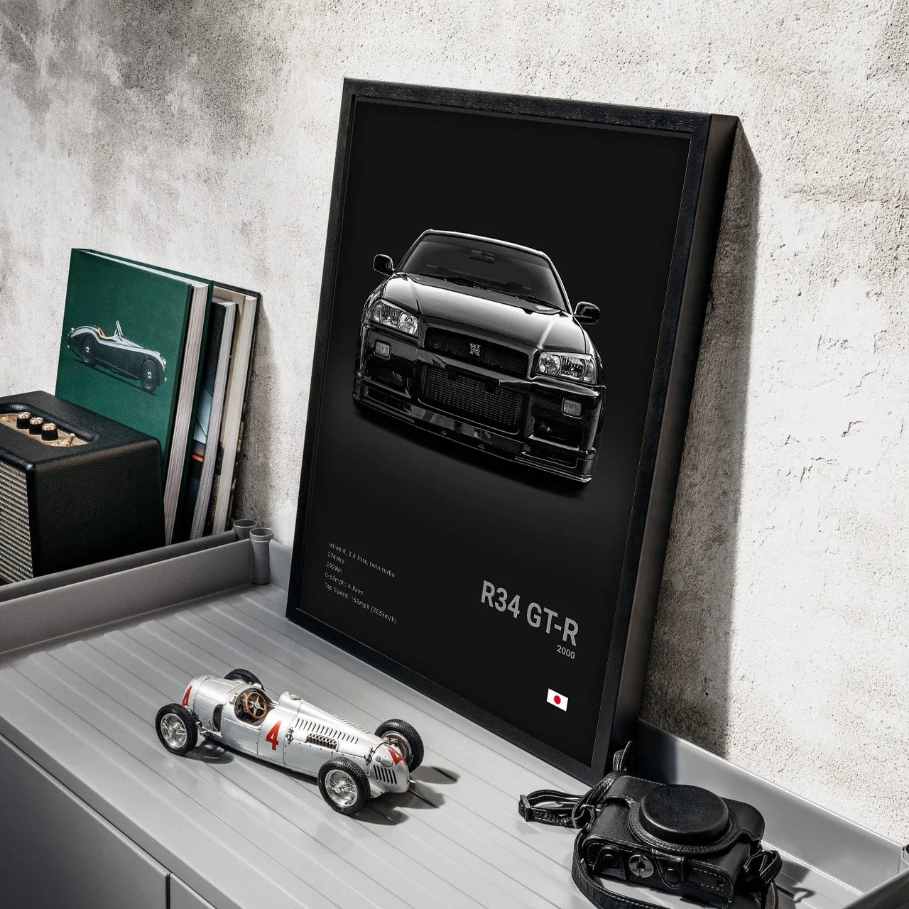 Framed poster of a car on a shelf with a toy car and camera