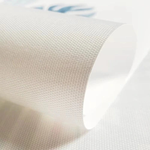 Close-up of a textured white fabric with a brand logo in the corner.