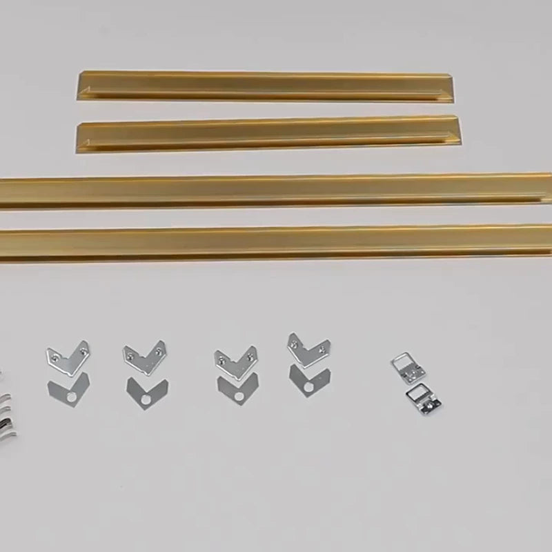 Gold metal strips and silver brackets on a white background