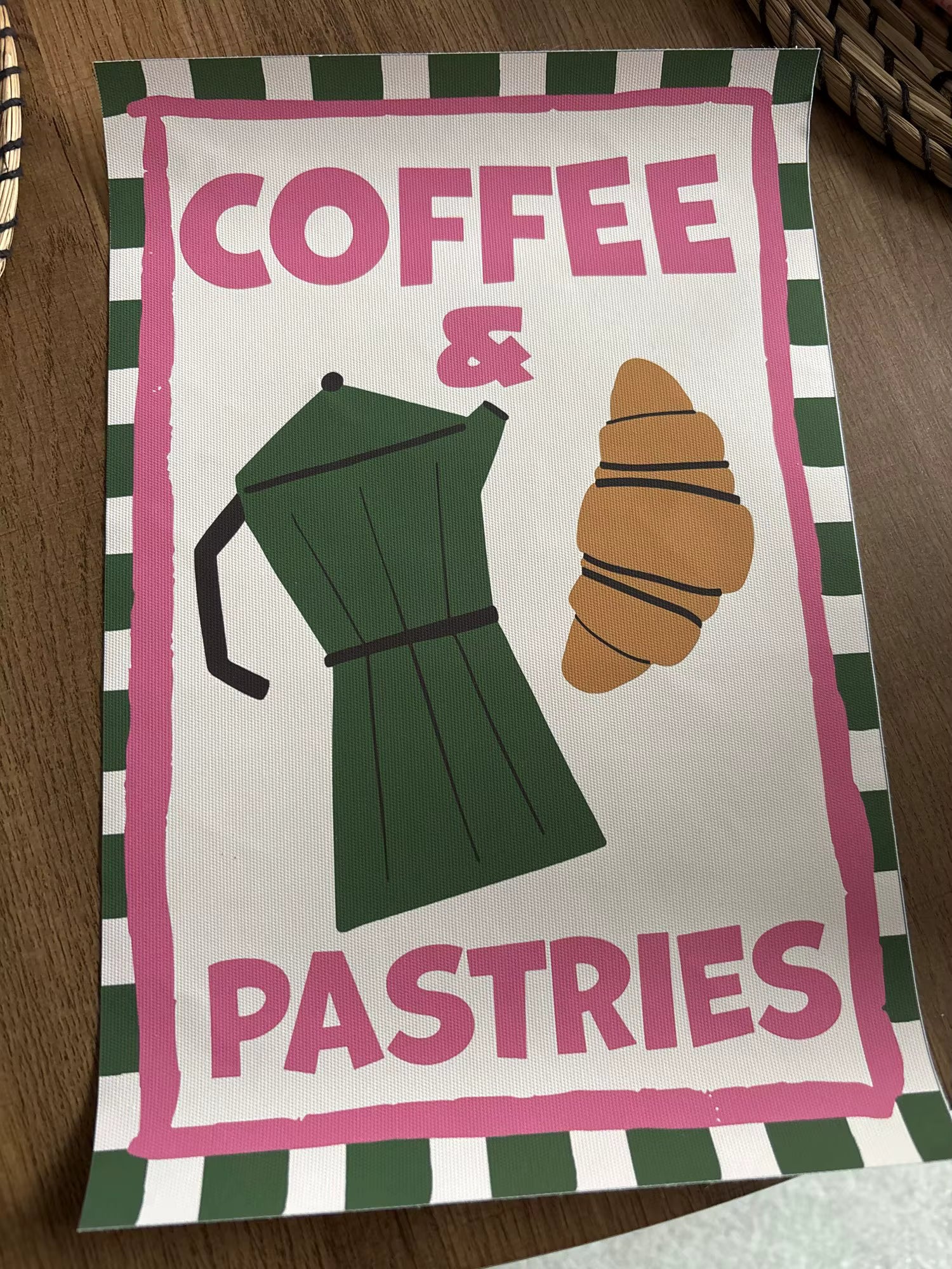 Tea towel with coffee pot and croissant design on a checkered background