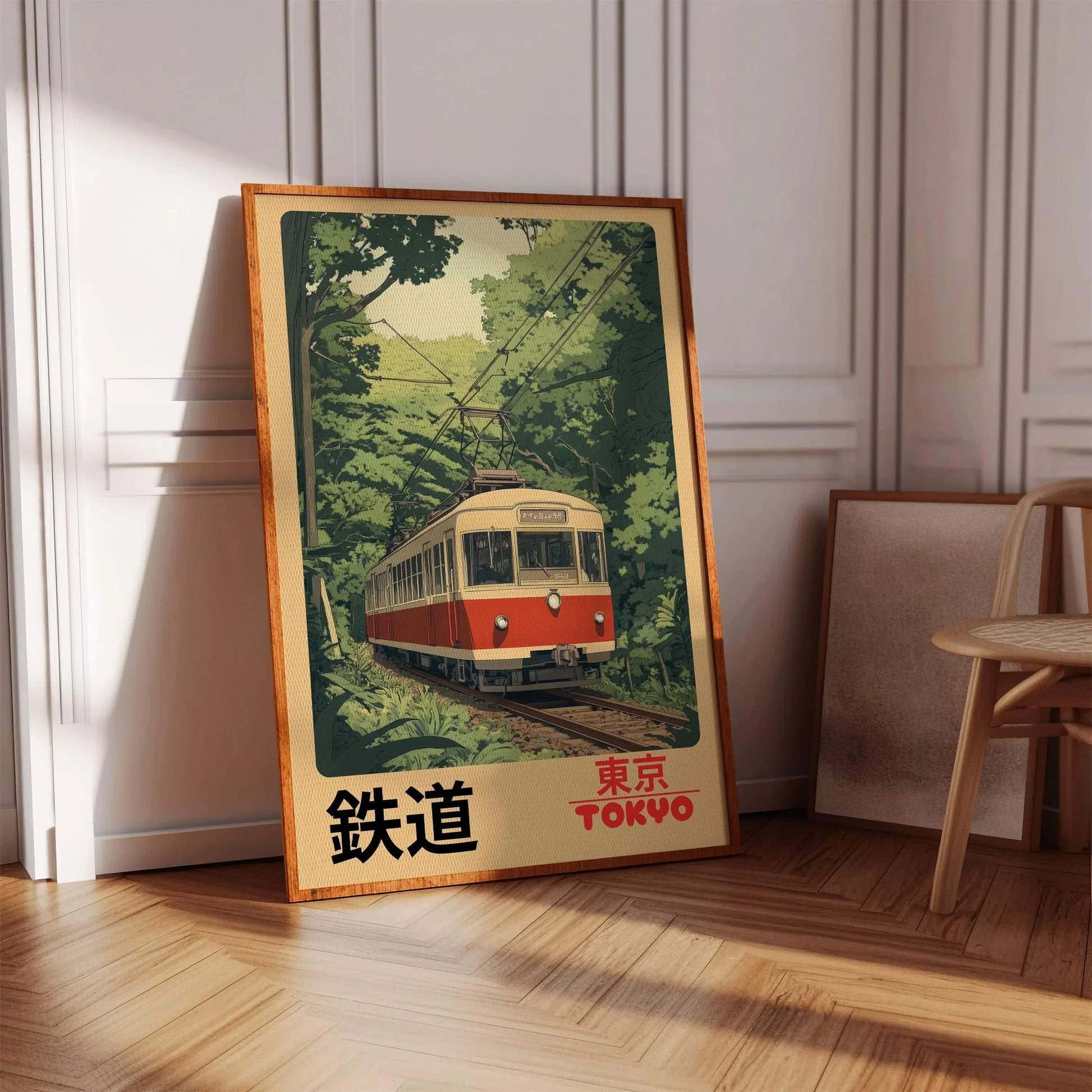 Framed poster of a train in a forest with 'Tokyo' text on a wooden floor.