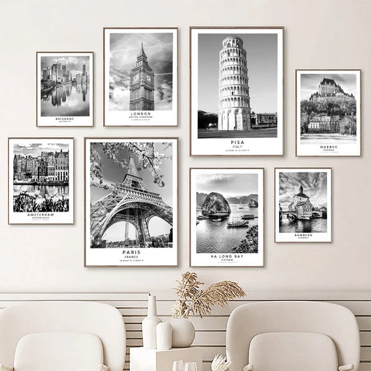 Set of black and white cityscape prints on a wall above a sofa. Canvas & Curio