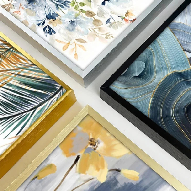Collection of framed artworks with floral and abstract designs on a white surface