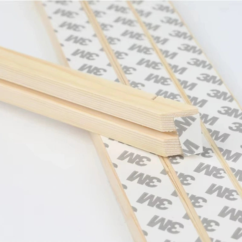 Wooden sticks on a white surface with '3M' branding.