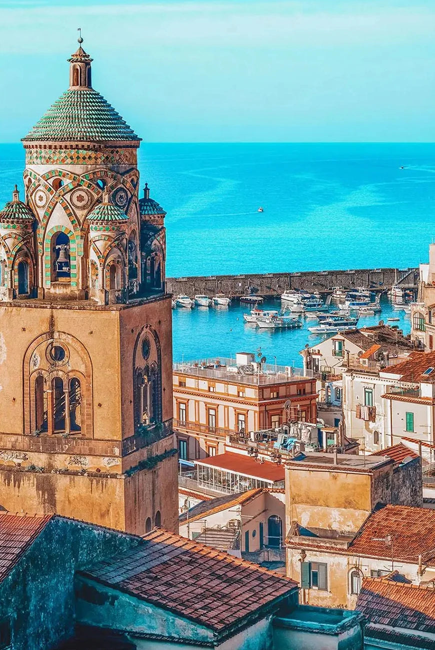 Cityscape with a prominent tower and harbor in the background