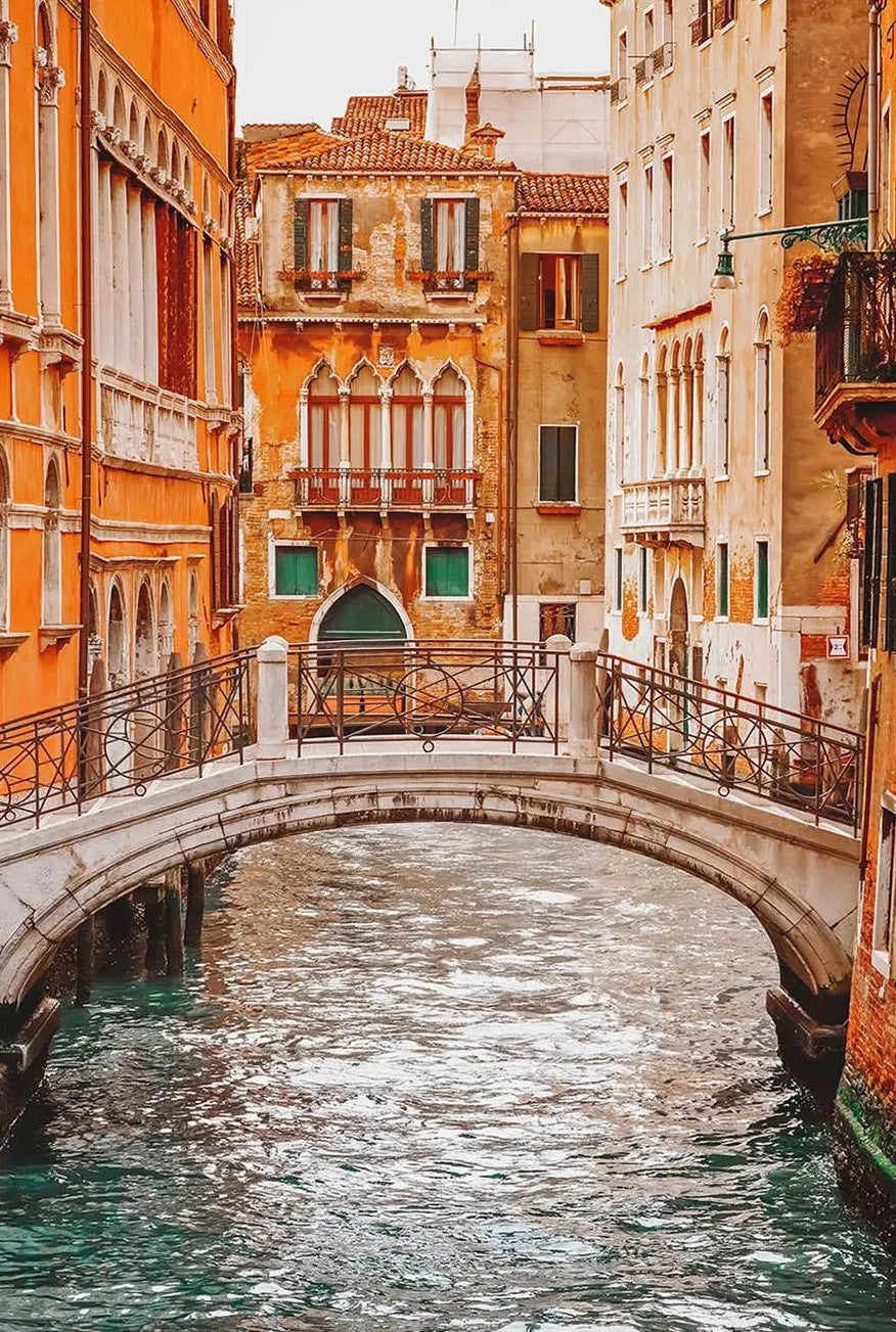 Venetian canal with a bridge and colorful buildings in Venice, Italy