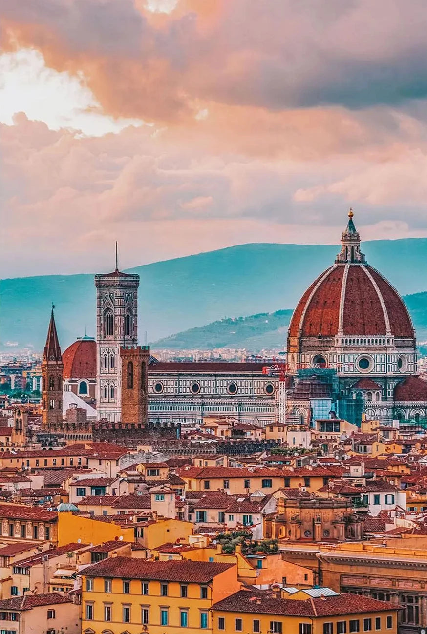 Cityscape with a prominent cathedral under a pinkish sky