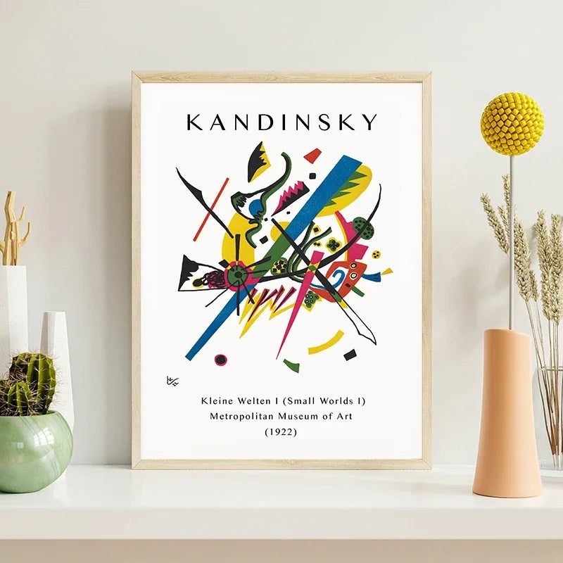 Framed Kandinsky artwork on a shelf with decorative items