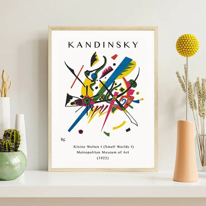 Framed Kandinsky artwork on a shelf with decorative items