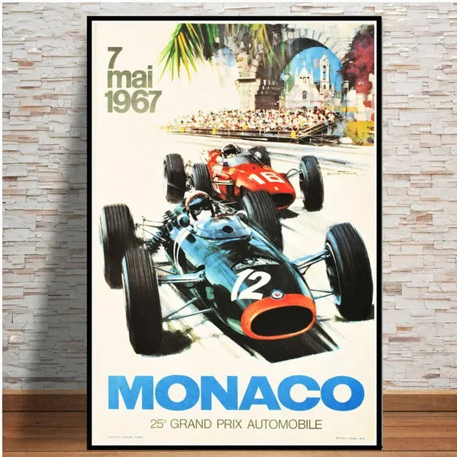 Vintage-style poster of two racing cars on a track with 'Monaco' and '1967' text, framed against a brick wall.