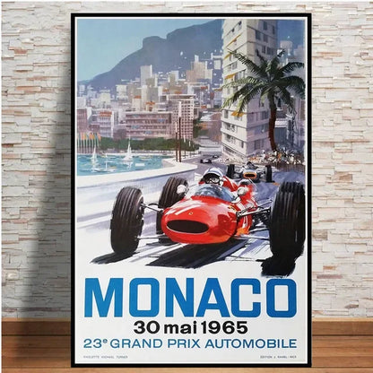 Poster of a red race car on a city street with 'Monaco' and '30 mai 1965' text, framed against a stone wall.