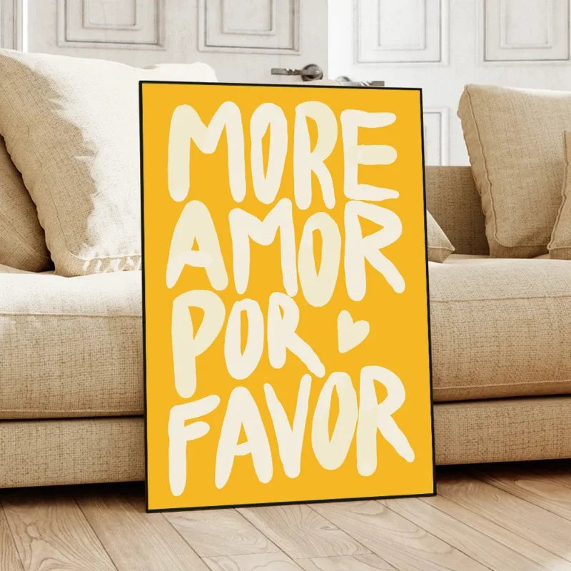 Yellow sign with white text 'MORE AMOR POR FAVOR' in a living room setting.