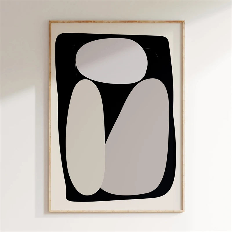 Abstract art print with geometric shapes in a wooden frame on a white wall