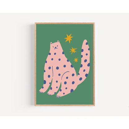 Framed artwork of a pink polka-dotted cat on a green background with yellow stars.