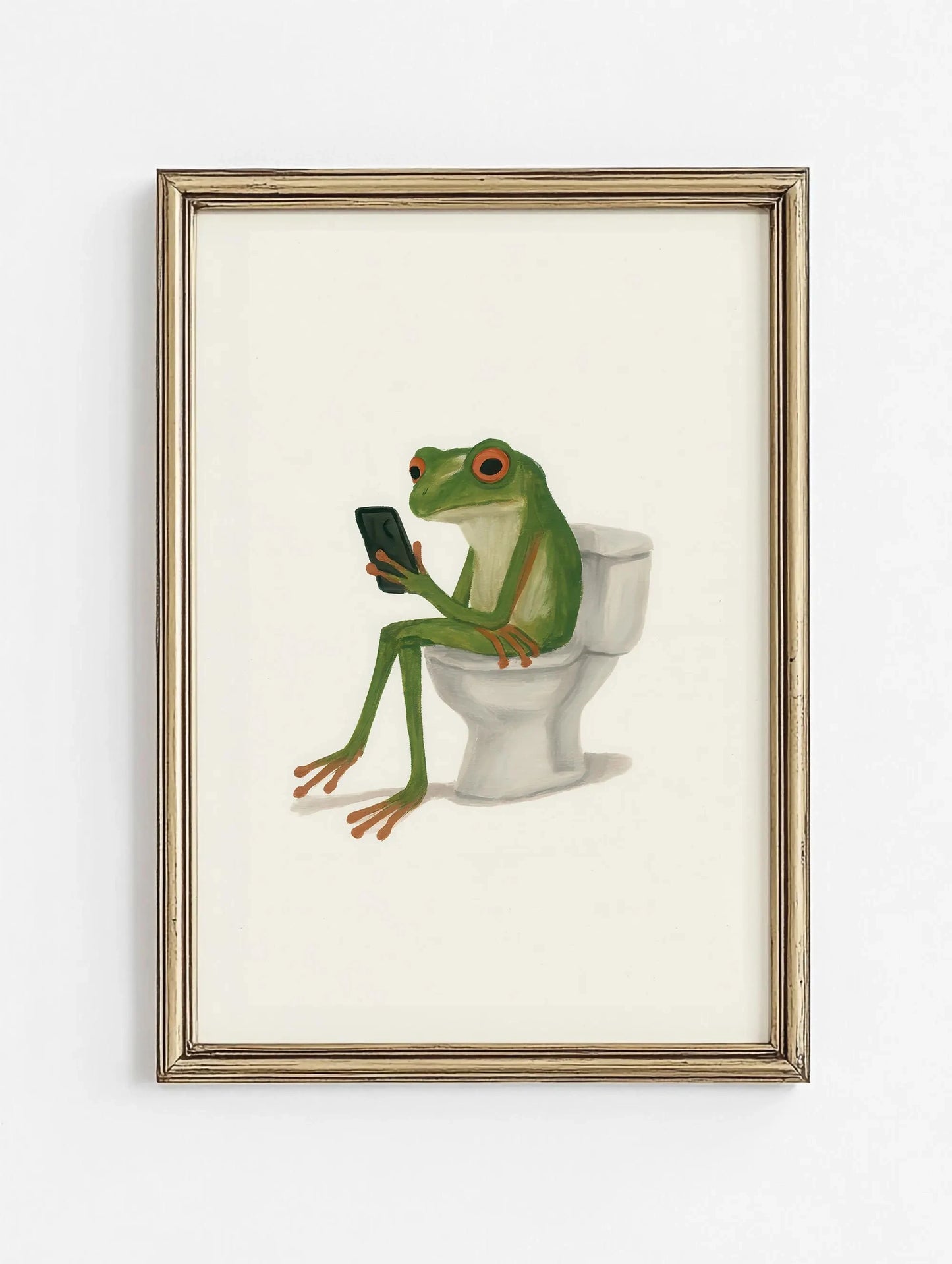 Framed artwork of a frog sitting on a toilet using a smartphone.