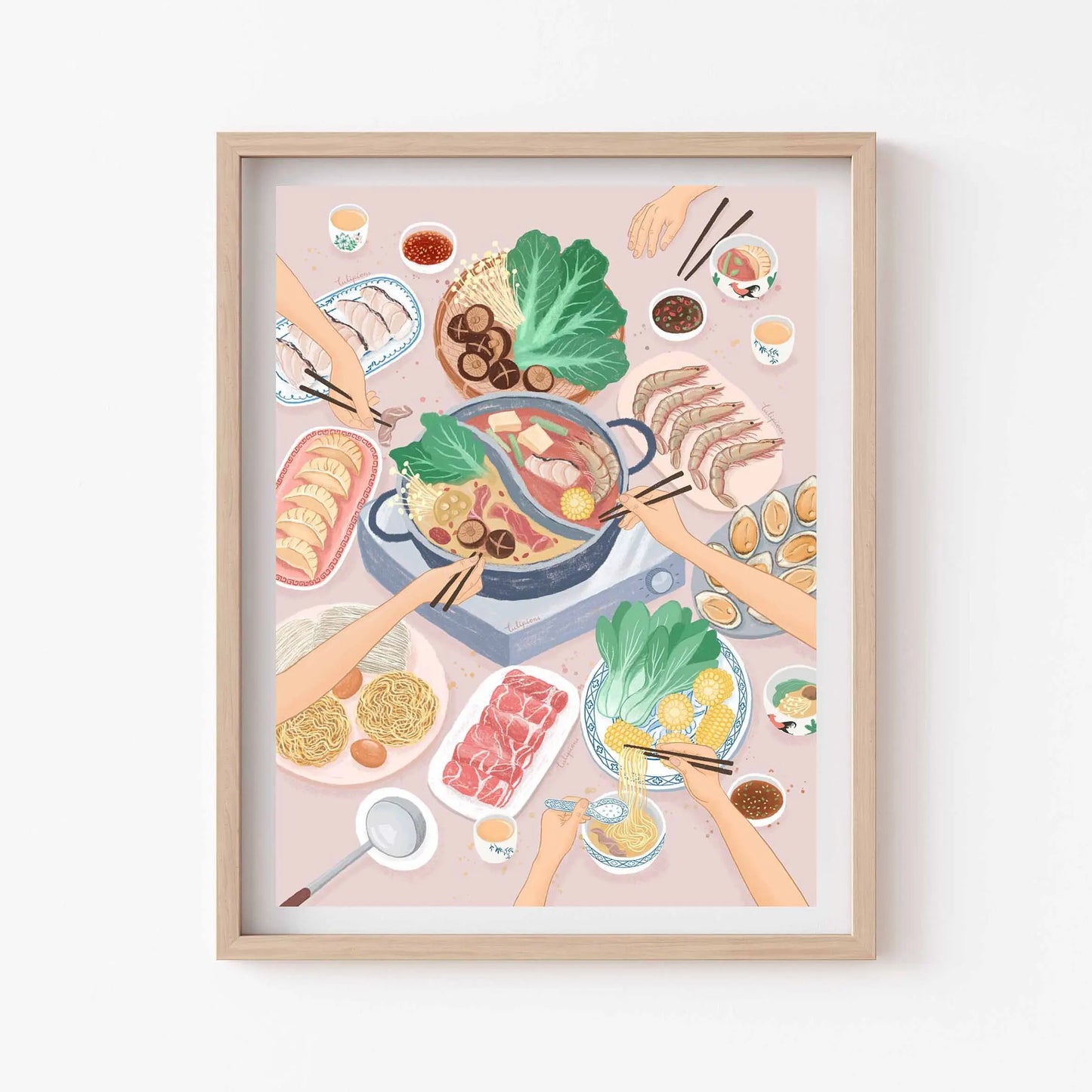 Framed artwork of a hot pot meal with hands and ingredients on a light background