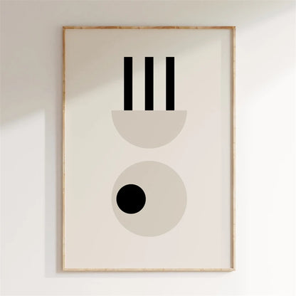 Framed abstract art print with geometric shapes on a white wall