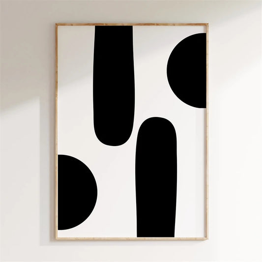 Framed abstract art with black shapes on a white wall Canvas & Curio