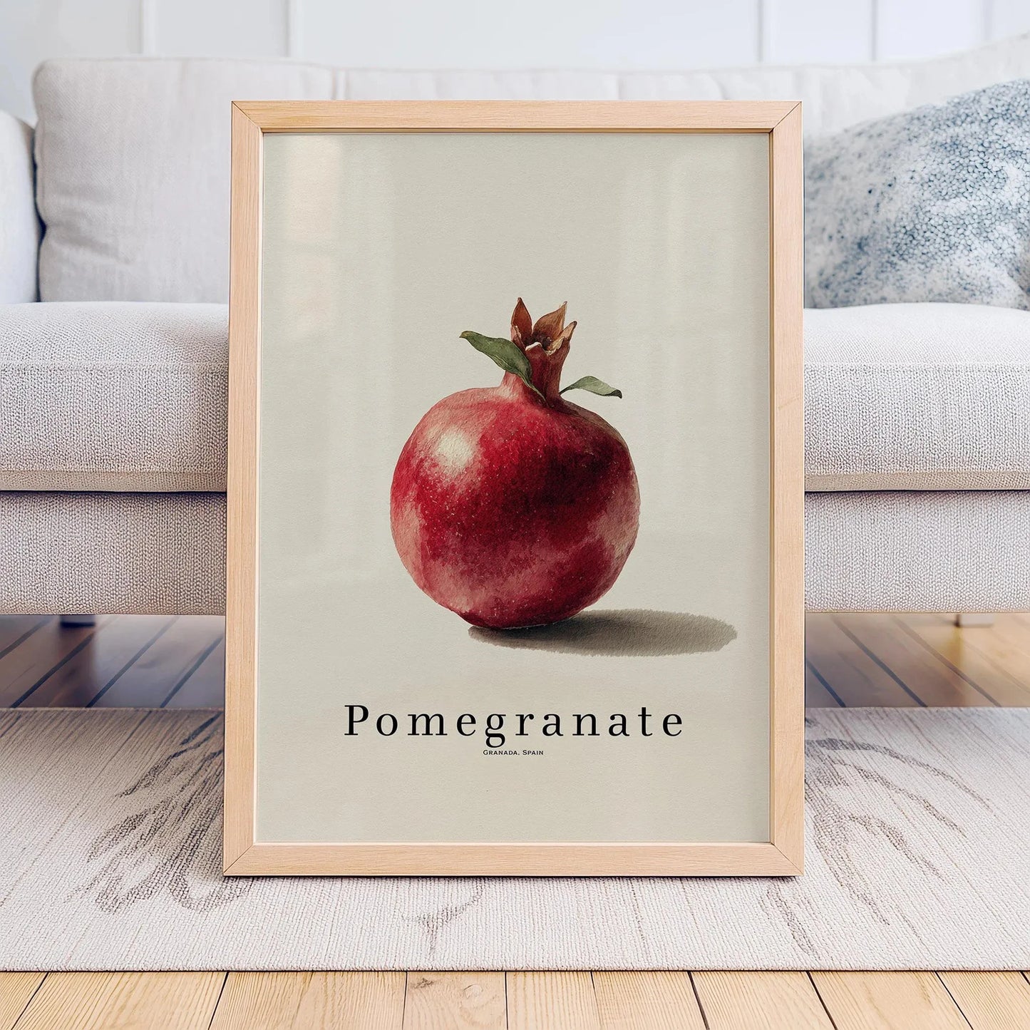 Framed artwork of a pomegranate on a neutral background