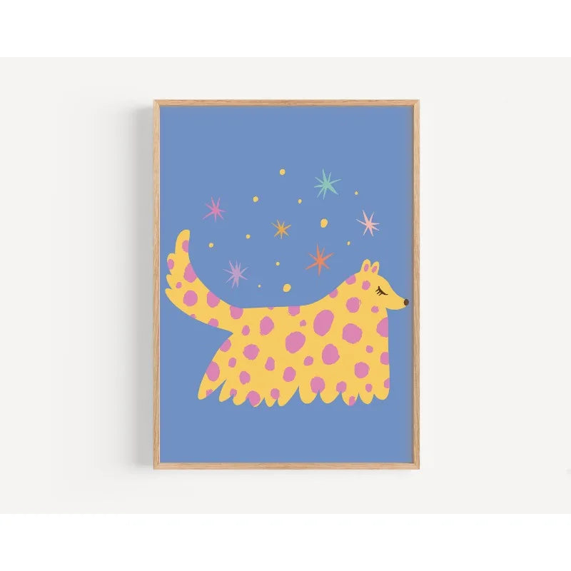 Framed artwork of a yellow and pink spotted creature on a blue background