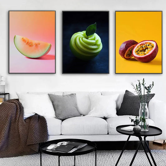 Three colorful fruit-themed wall art prints above a white sofa in a living room. Canvas & Curio