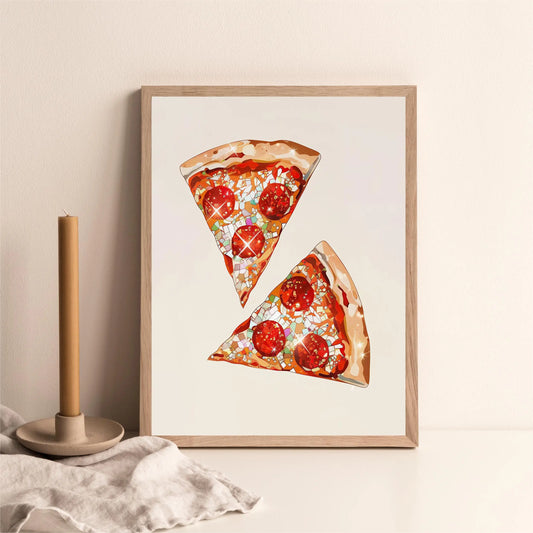 Framed artwork of two slices of pizza on a beige wall with a candle and fabric in the foreground. Canvas & Curio