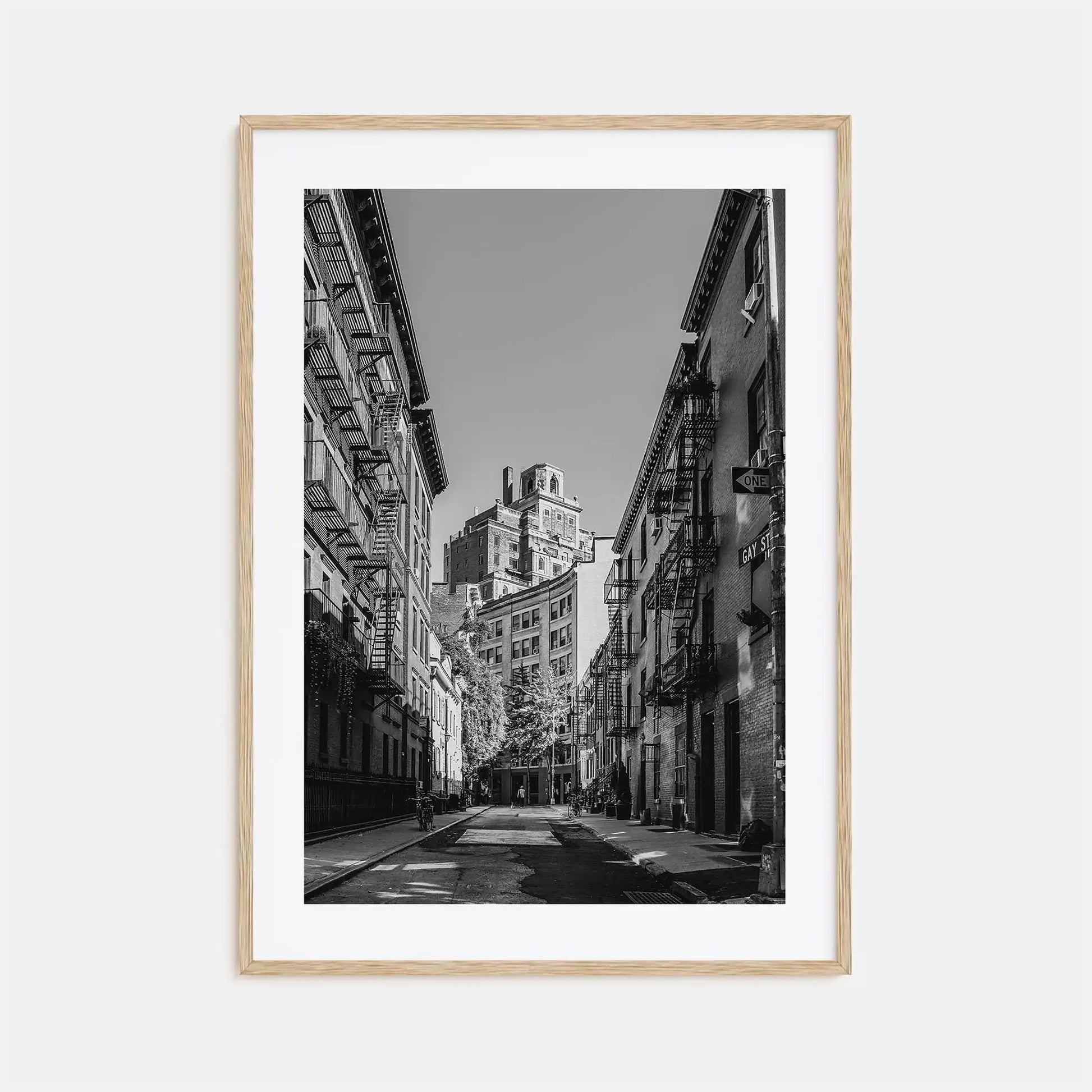 Framed black and white city street photograph with tall buildings.