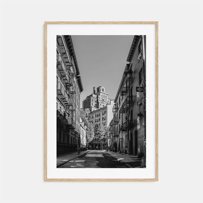 Framed black and white city street photograph with tall buildings.