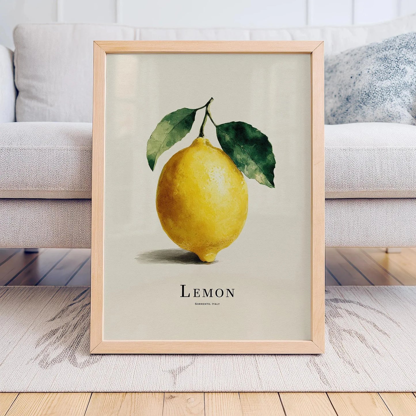 Framed artwork of a lemon with leaves on a neutral background
