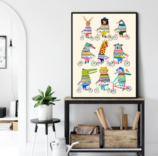 Framed colorful animal illustration on a wall above a shelf with books and plants. Canvas & Curio