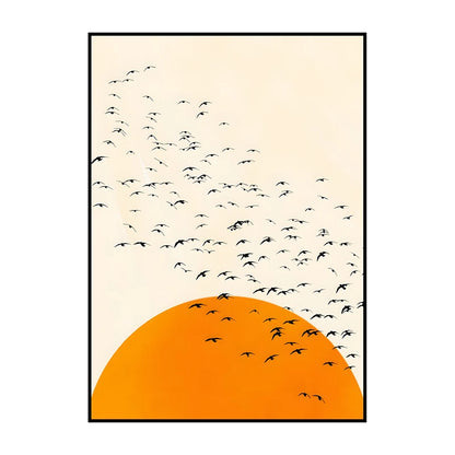 Framed artwork with black birds flying against an orange sunset on a beige background