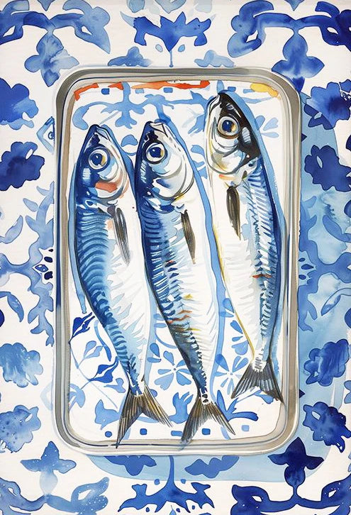 Three fish in a metal tray on a blue and white patterned background