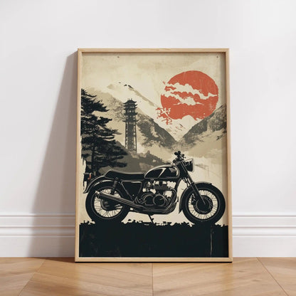 Framed artwork of a motorcycle with a mountain and red sun background on a white wall.