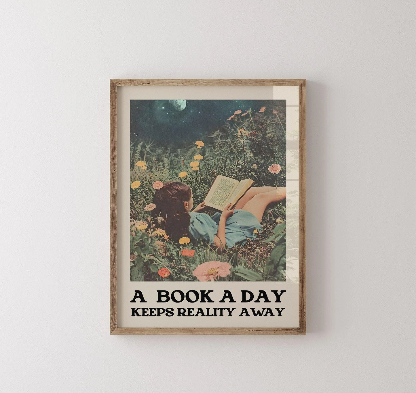 Framed artwork of a woman reading a book in a garden with text 'A Book A Day Keeps Reality Away' on a white wall.