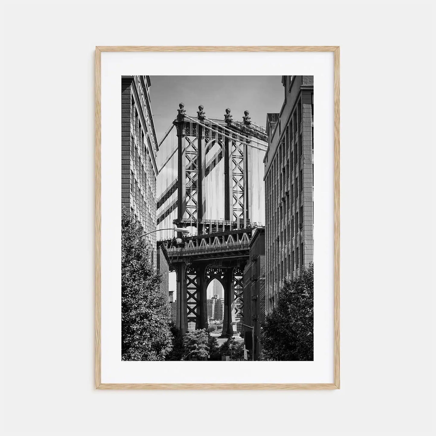 Framed black and white photograph of a bridge with a cityscape background