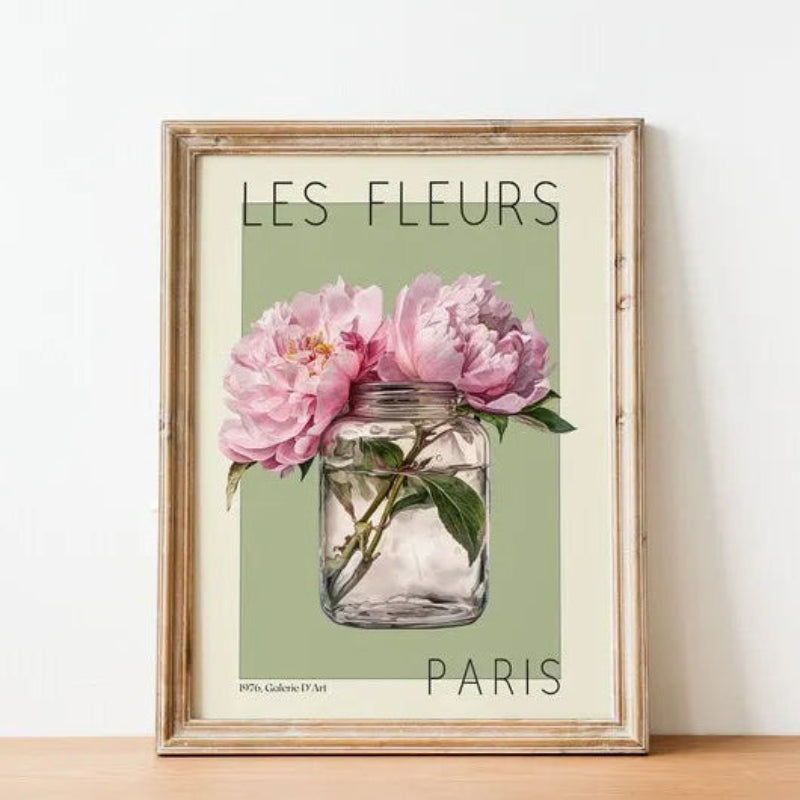 Framed artwork with 'Les Fleurs Paris' text and pink flowers in a jar on a light background