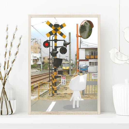 Framed photograph of a railway crossing with traffic lights and a train. Canvas & Curio