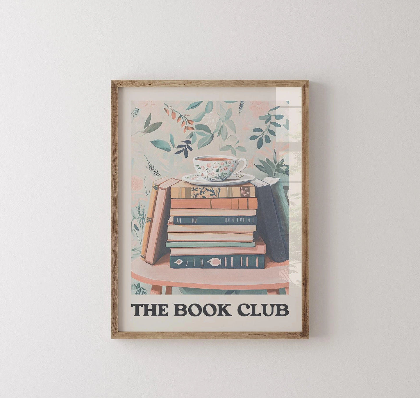 Framed artwork with 'The Book Club' text and book illustration on a white wall.