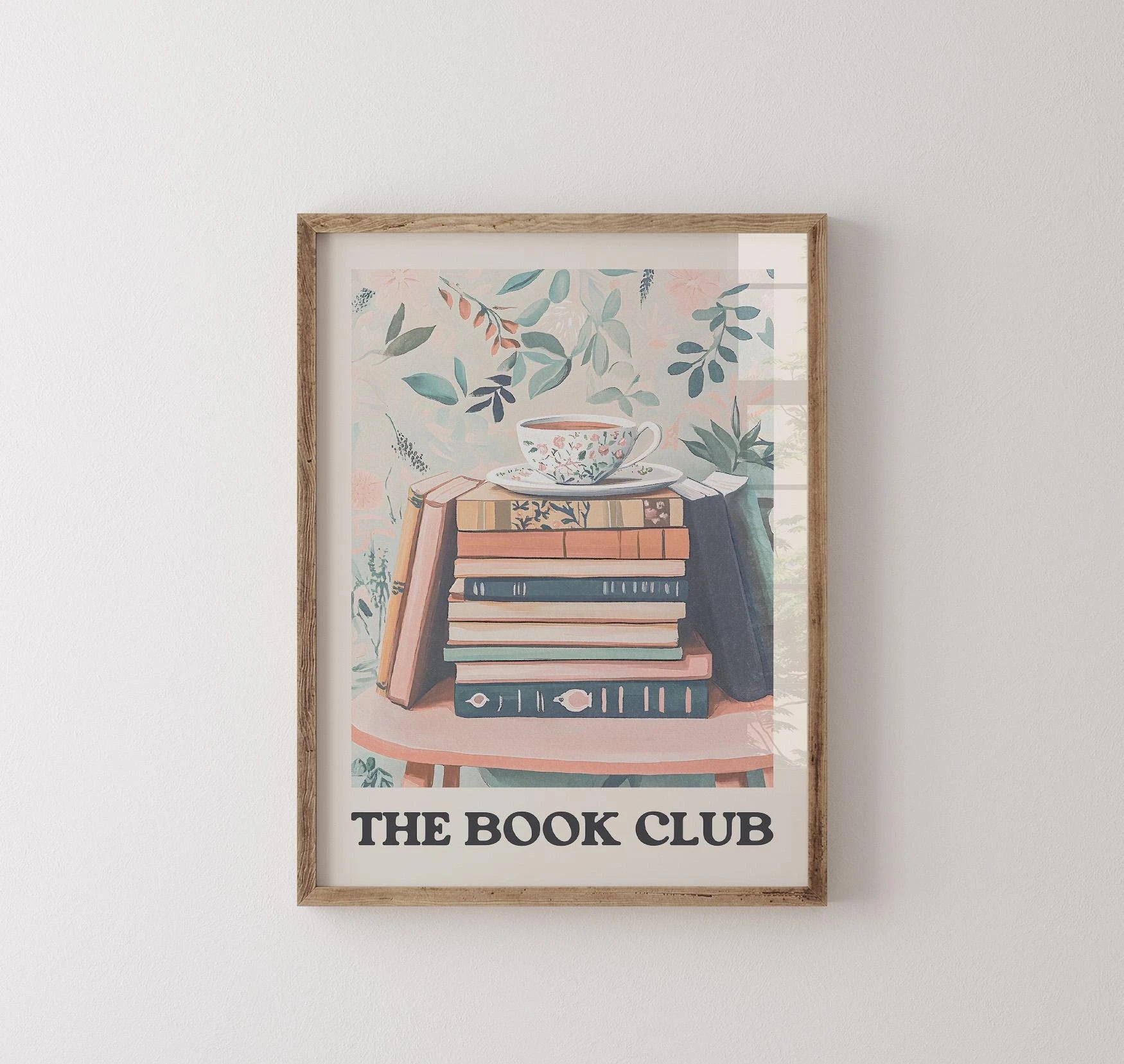 Framed artwork with 'The Book Club' text and book illustration on a white wall.