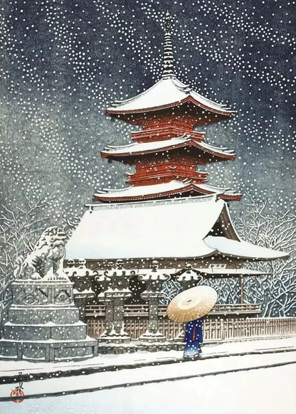 Traditional Japanese pagoda in the snow with a person holding an umbrella.