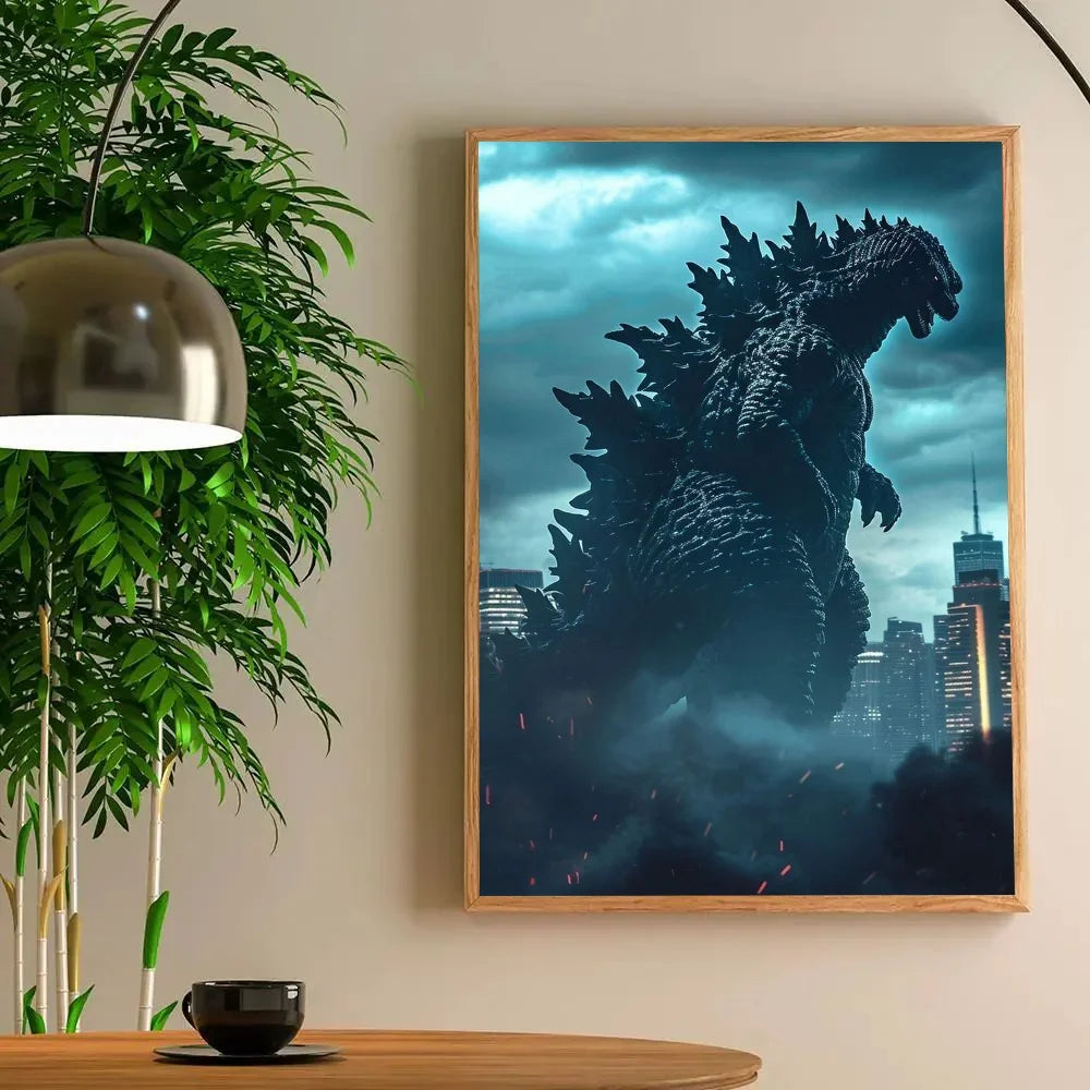 Framed poster of Godzilla in a cityscape on a wall with a plant and table in the foreground.