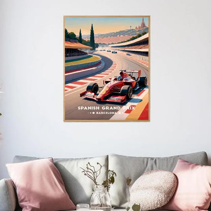 Poster of a race car on a track with 'Spanish Grand Prix' text, above a sofa with decorative pillows.