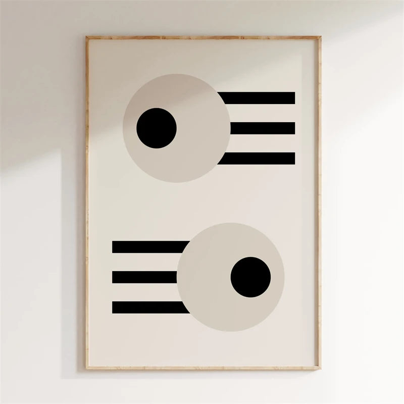 Framed abstract art with geometric shapes on a white wall