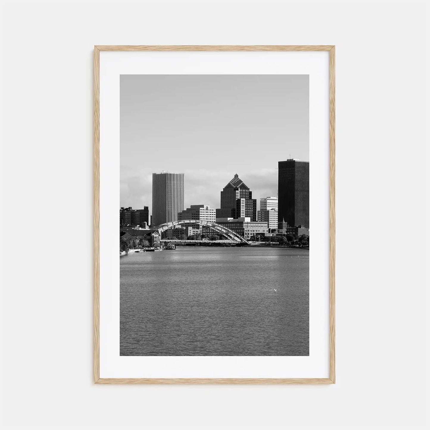 Framed black and white cityscape print with a river and skyline.