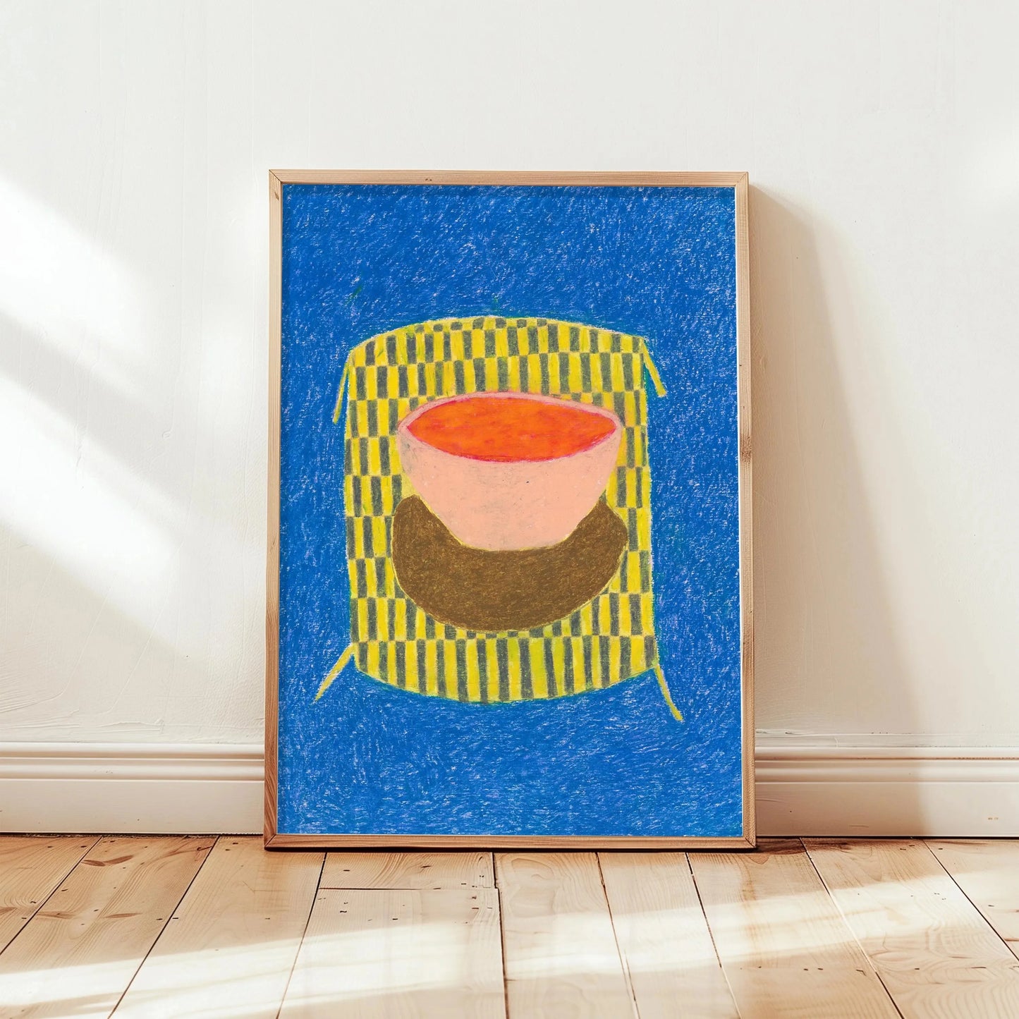 Framed abstract artwork with a colorful design on a blue background, displayed on a white wall.