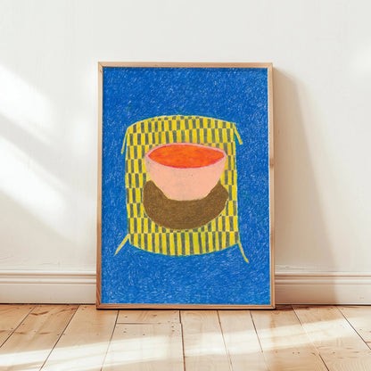 Framed abstract artwork with a colorful design on a blue background, displayed on a white wall.