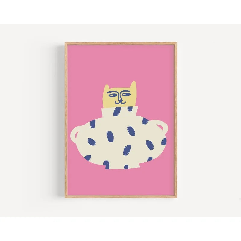 Framed artwork of a cat with blue spots on a pink background
