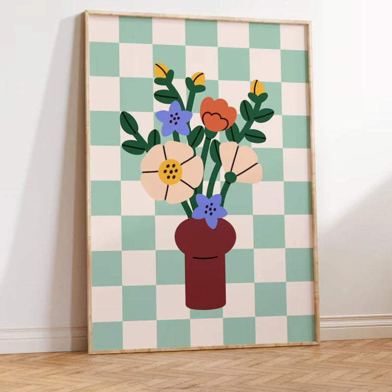 Framed artwork of a vase with flowers on a checkered background