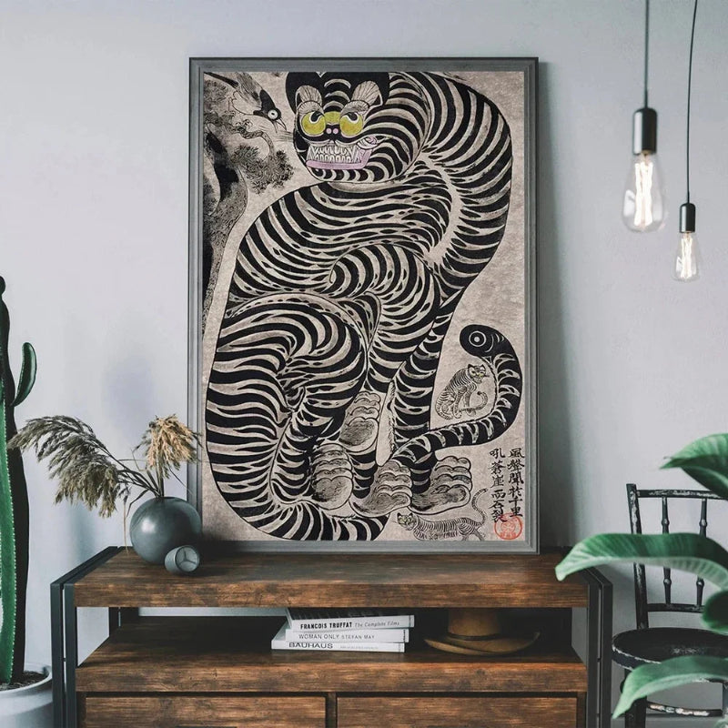 Framed artwork of a stylized tiger on a wooden console table with plants and books.