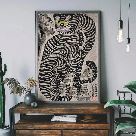 Framed artwork of a stylized tiger on a wooden console table with plants and books. Canvas & Curio